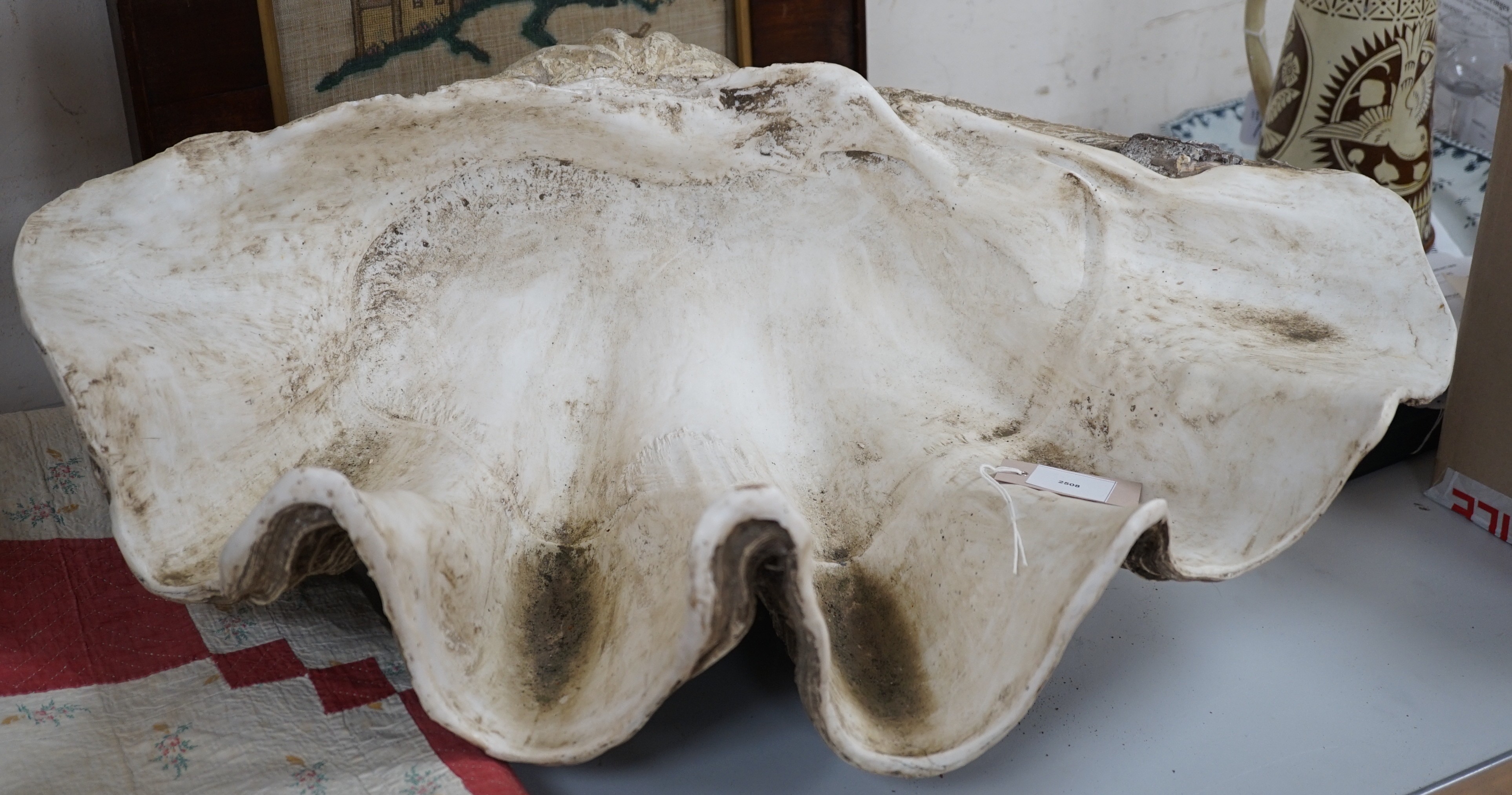 A large composite conch shell garden ornament, 72 cms wide